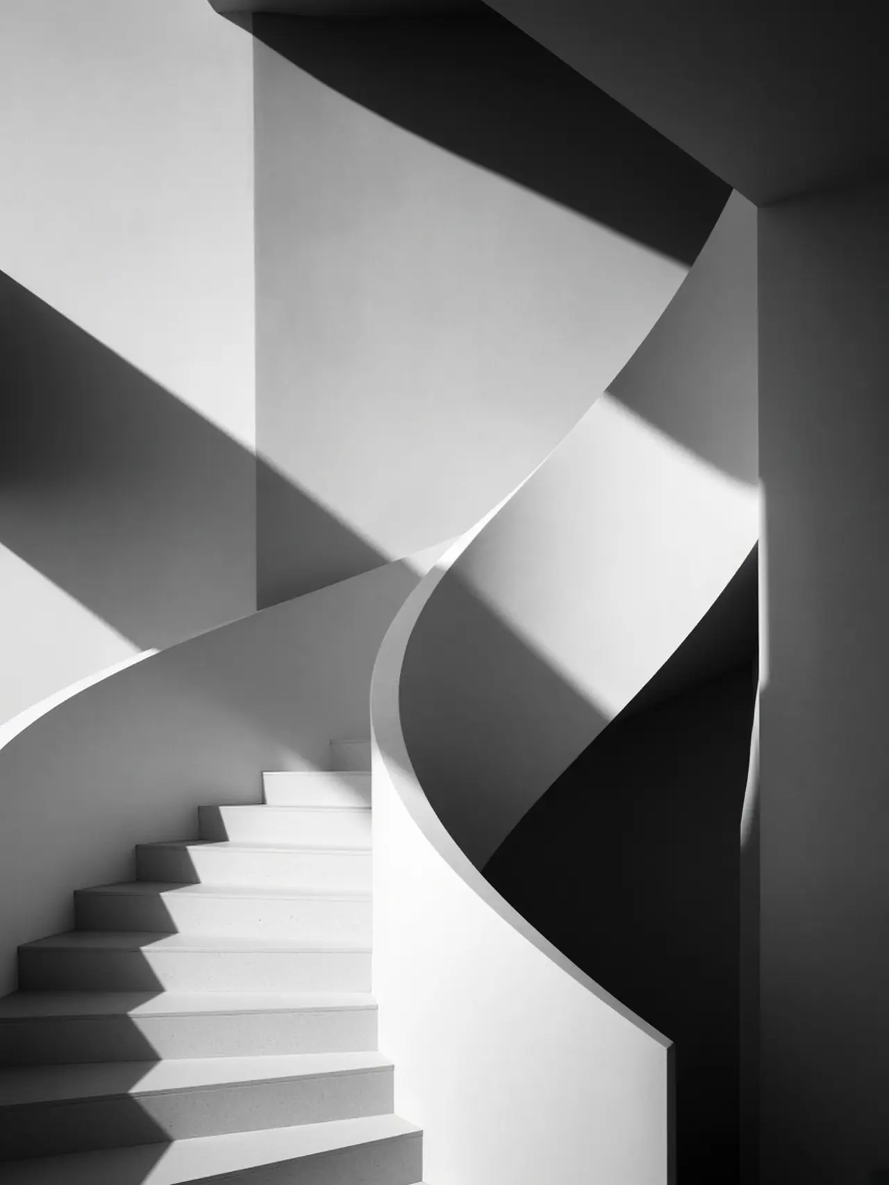 A curved white concrete staircase in black and white
